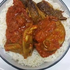 A picture of Rice with tomato stew.
