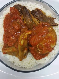A picture of Rice with tomato stew.