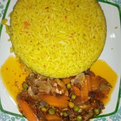 Yellow jollof rice with chicken beast sauce A picture of Yellow jollof rice with chicken beast sauce.