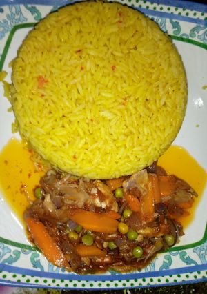 A picture of Yellow jollof rice with chicken beast sauce.