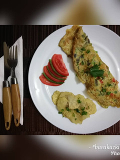 A picture of Breakfast Omelette with a side of spiced baked potatoes.