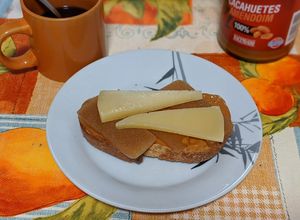 Foto principal de Tostada integral con crema de cacahuete, membrillo y queso añejo fuerte