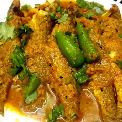 A picture of Shorshe Posto Parshe/Mullet fish in mustard poppy seed paste.