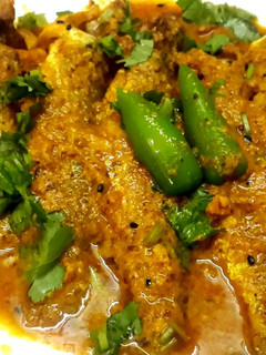 A picture of Shorshe Posto Parshe/Mullet fish in mustard poppy seed paste.