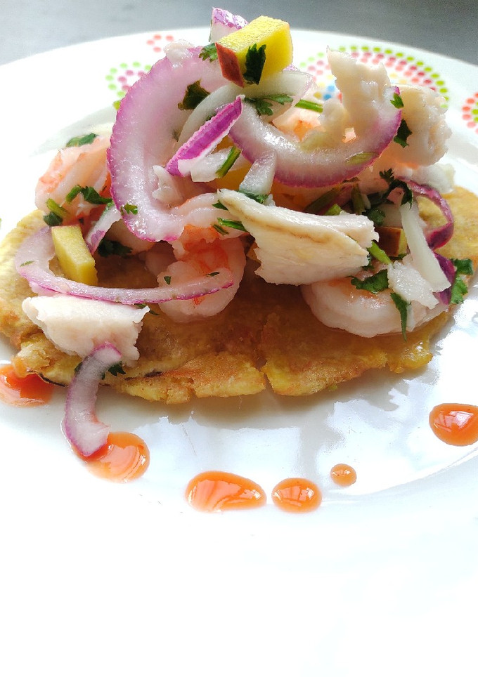 Una foto de Patacones de guineo con ceviche de pescado blanco y camarón