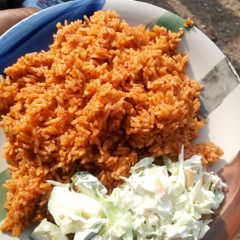 A picture of Jollof rice and salad.