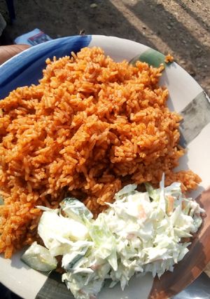 A picture of Jollof rice and salad.