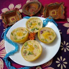 A picture of Orange phirni  in orange cup.
