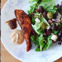 A picture of Ras El Hanout Salmon with salad.
