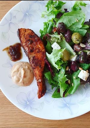 A picture of Ras El Hanout Salmon with salad.