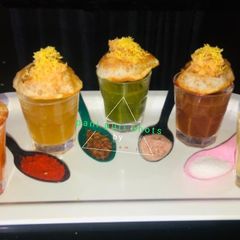 A picture of 5 flavoured pani puri shots.