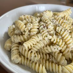 A picture of Lebanese style pasta with yogurt and garlic sauce.