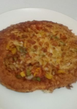 A picture of Home made pizza with vegetables n cheese toppings.