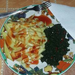 A picture of French fries with freid pumpkin leaves (kahurura).