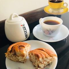 A picture of Cinnamon Rolls with Black Coffee.