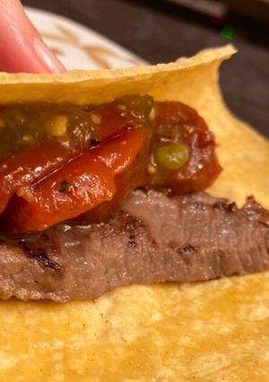 A picture of Beef Sirloin Tacos with Roasted Peppers and Green Tomatillo Salsa with Spicy Sauce.