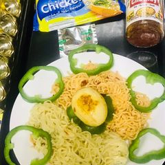 A picture of Chicken schezwan Maggi noodles and tossed boiled egg with Maggi seasoning.