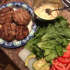 A picture of Turkey and avocado burgers with honey mustard sauce.