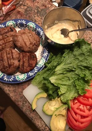 A picture of Turkey and avocado burgers with honey mustard sauce.