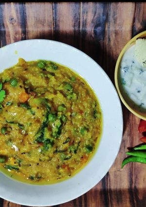 A picture of Shahi Paneer Daliya Khichdi with Cucumber Raita.