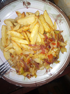 A picture of Fried potatoes and cabbage sauce.