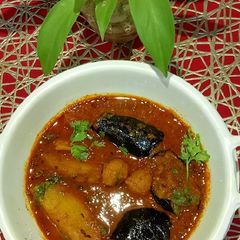 A picture of Brinjal potatoes lentils dry dumplings Gravy.
