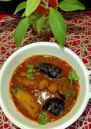 A picture of Brinjal potatoes lentils dry dumplings Gravy.