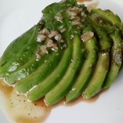 A picture of Avocado fan with vinaigrette.