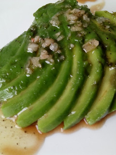 A picture of Avocado fan with vinaigrette.