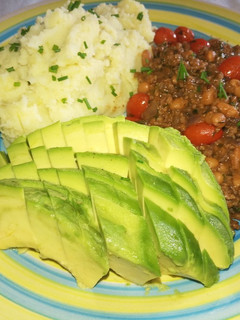 A picture of Mashed potatoes in coconut cream, minced beef & beans.