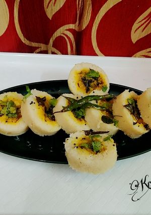 A picture of Semolina stuffed glass Dhokla.