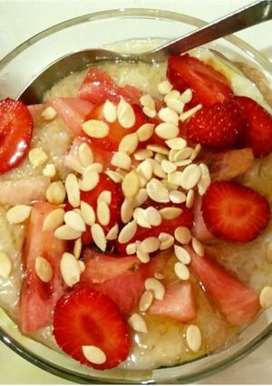 A picture of Oatmeal with fruits and nuts.