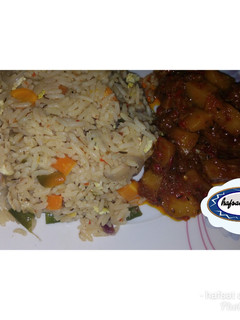 A picture of White jollof rice with potato sous.
