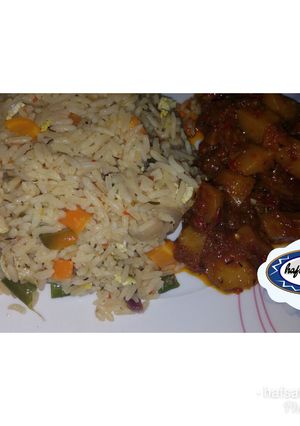 A picture of White jollof rice with potato sous.