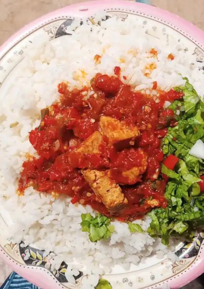 A picture of Rice and stew with salad.