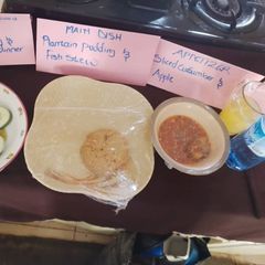 A picture of Plantain pudding with fish sauce.
