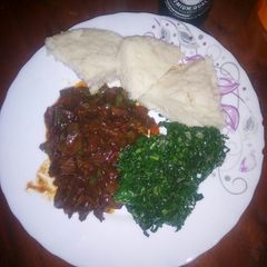 A picture of Liver served with ugali and greens.