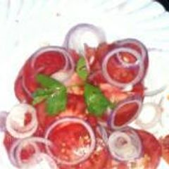 A picture of Tomato & onion salad.