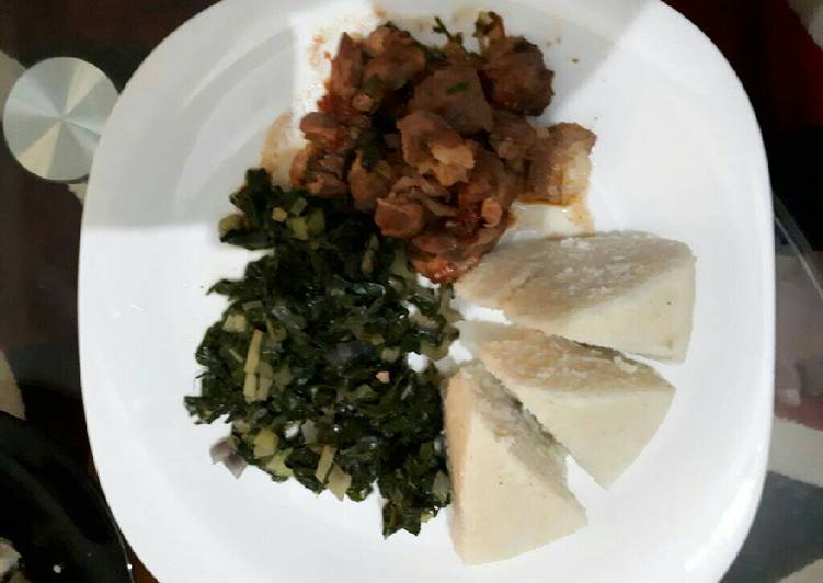 Goat stew served with ugali and spinach