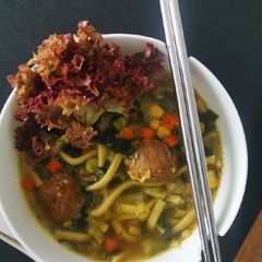 A picture of Meatballs and noodle soup.