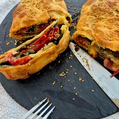 A picture of Stromboli with veggies, serrano ham and gorgonzola.