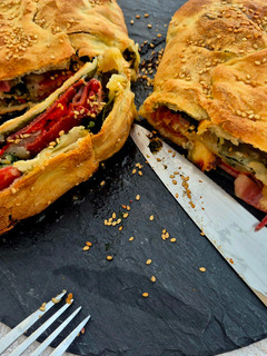 A picture of Stromboli with veggies, serrano ham and gorgonzola.