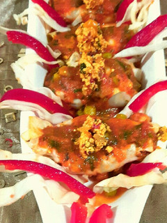 A picture of Paneer packets in tomato gravy.