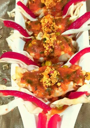 A picture of Paneer packets in tomato gravy.