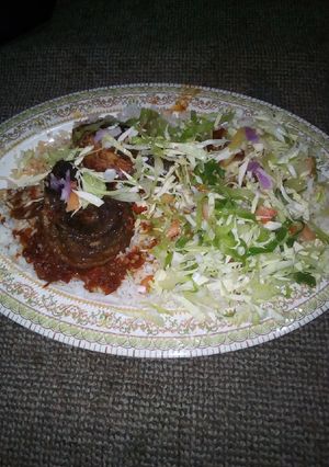 A picture of Rice with fish and cabage.