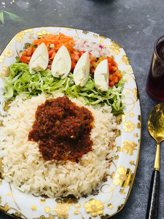 A picture of Rice & Stew with Salad.