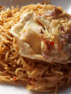 A picture of Pasta with fried egg.