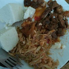 A picture of Ugali, cabbages and wet fried beef.