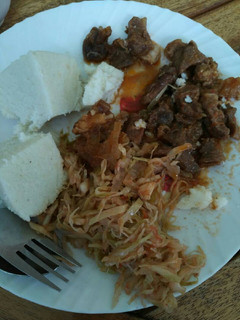A picture of Ugali, cabbages and wet fried beef.