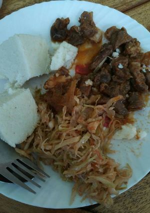 A picture of Ugali, cabbages and wet fried beef.